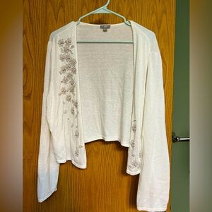Open knit cardigan with crochet flower details.